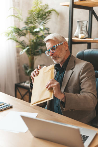 istock Judicial mail. A surprised man opens documents, a court decision 1318499784