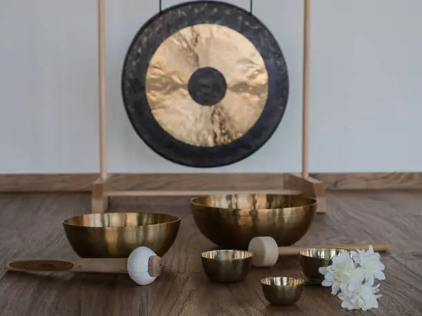 Gong in background , five singing bowls foreground