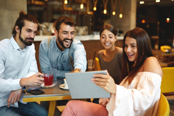 istock Group of Happy friends having with digital tablet in cafe 1318502297