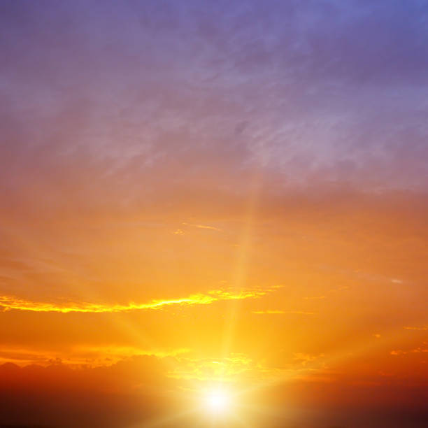 istock Sunset with sun and clouds on blue and orange dramatic sky with sun rays 1318503271