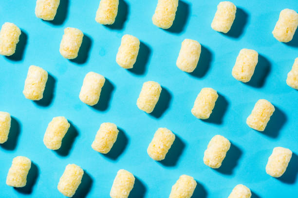 istock A trendy background of corn sticks on a blue backdrop in harsh light. Top view 1318503786