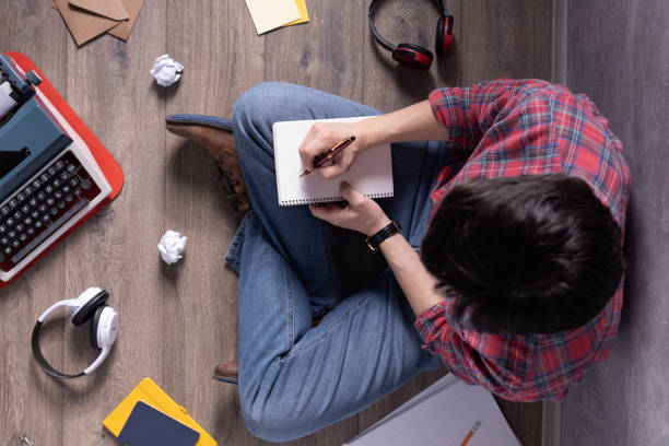 istock Man writing in notebook noting thinking idea solitions. Student man online larning. Creative inspiration concept 1318505227