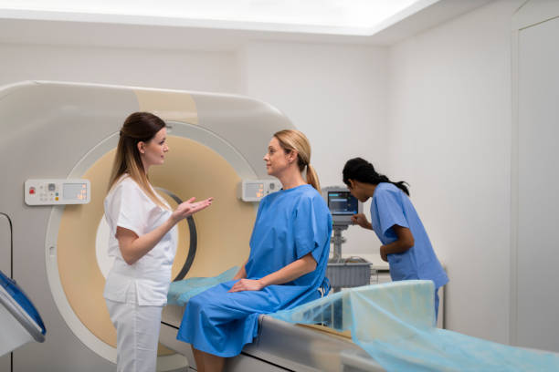 istock Mature woman talking with a doctor before CAT scan 1318505365