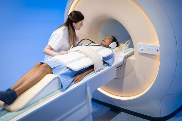 istock Female radiologist preparing her patient before enter the MRI scanner 1318505654