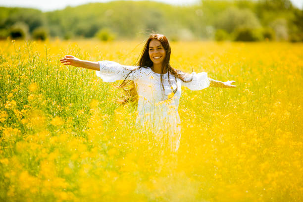 istock Young woman in the rapeseed field 1318505963
