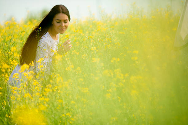 istock Young woman in the rapeseed field 1318506314