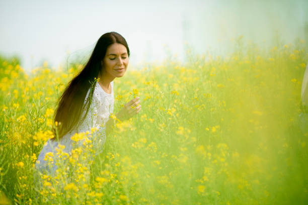 istock Young woman in the rapeseed field 1318506353