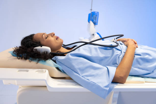 istock Mature woman lying on MRI scanner before a scan 1318506554