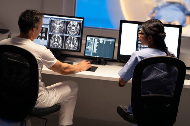 istock Two MRI radiologists sitting in the control room and operating the MRI scanner 1318507790