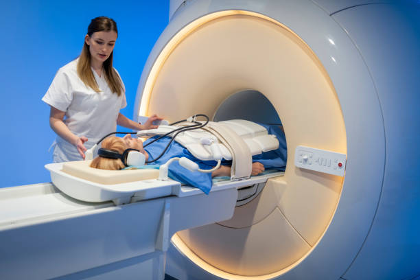 Female doctor sliding her patient into the MRI scanner