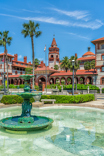 St. Augustine, USA - May 10, 2018: Flagler College vertical view with green water fountain in Florida and architecture famous statue in historic city