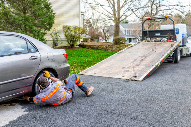 Car in driveway with tower man attaching chain to tow vehicle due to fuel leak that damaged pavement covered in cat litter to absorb the gas Herndon, USA - November 21, 2020: Car in driveway with tower man attaching chain to tow vehicle due to fuel leak that damaged pavement covered in cat litter to absorb the gas car towing a house stock pictures, royalty-free photos & images