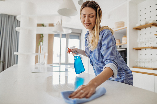 Woman using modern wireless vacuum cleaner at home. Cleaning service worker. Concept of cleanliness. Household equipment usage. Housewife duties