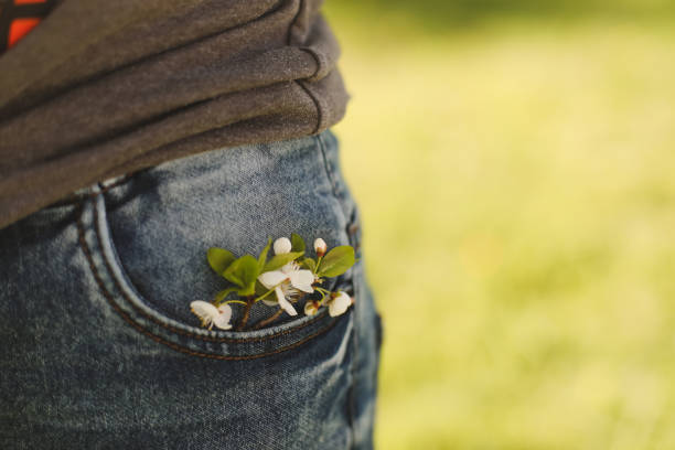 istock blossoming tree branch in jeans pocket close-up 1318514299