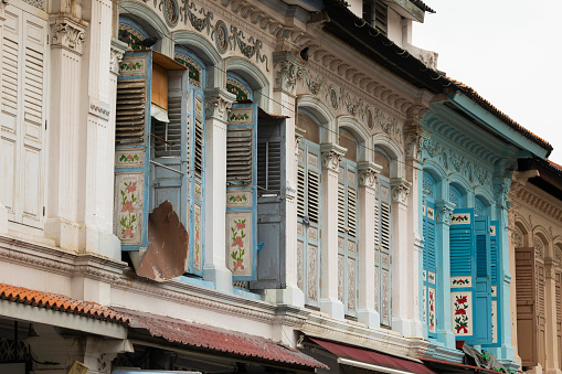 Brightly painted windows on the facades of buildings in Little India and China town, near Rochor, in Singapore, Southeast Asia. Beautiful example of colonial style architecture.