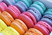 Multicolored  rainbow macaroon desserts. Delicious french macaroons with filling