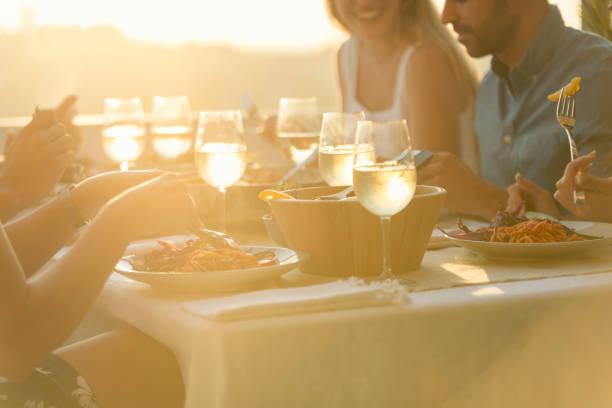 istock Friends enjoying a meal together on a table at sunset. 1318518278