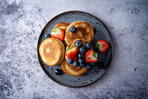 Banana pancakes with strawberries and blueberries. toning. selective focus