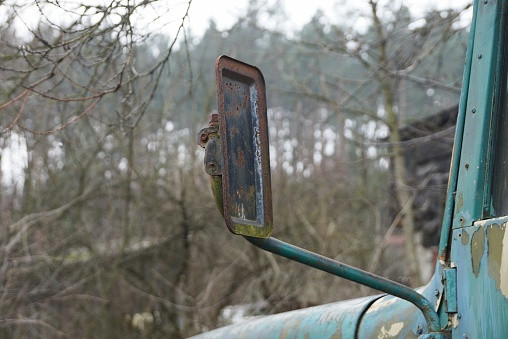old iron rusty ferris mirror on a retro truck on the street