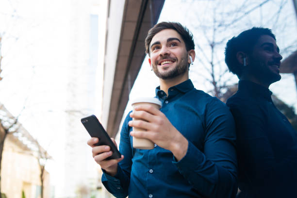 istock Young man using his mobile phone outdoors. 1318519653