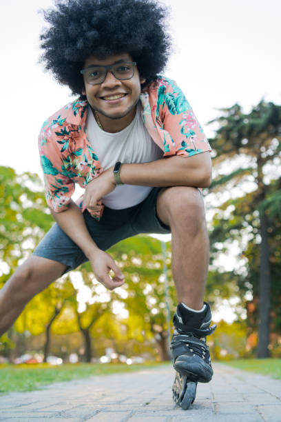 istock Latin man rollerskating outdoors. 1318520275