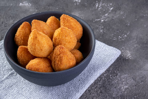 istock Traditional Brazilian fried snack stuffed with chicken . Coxinha de frango 1318520465
