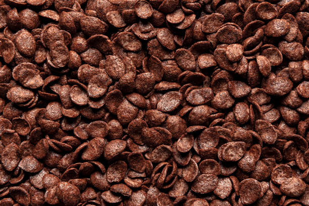 istock Chocolate cornflakes cereal, background, top view. Breakfast cereals close-up, full-frame 1318520529