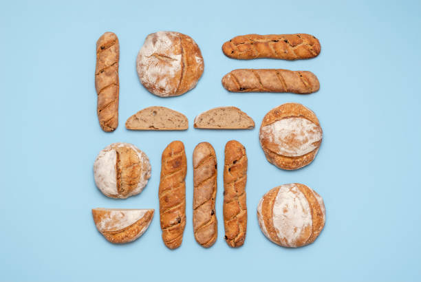 Sourdough bread variety top view on a blue background. Homemade bread flat lay.
