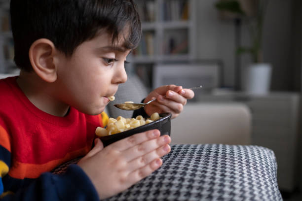 istock 4-5 years old cute child eating spaghetti. 1318520587