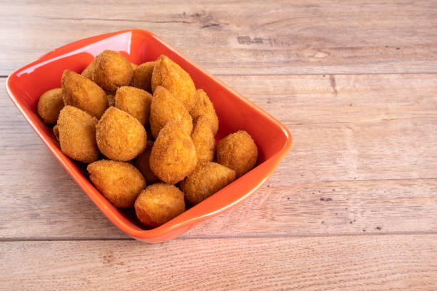 istock Traditional Brazilian fried snack stuffed with chicken . Coxinha de frango 1318520776