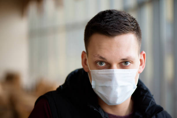 istock Portrait of a young guy wearing protection face mask against coronavirus. 1318523708