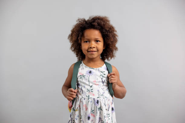 istock Little Girl With Backpack Looking At Camera 1318524080