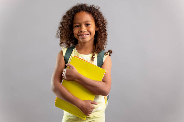 istock Young Girl Wearing Backpack And Holding A Notebook 1318524122