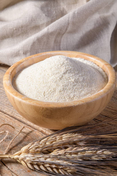 whole wheat durum flour in wooden bowl on a wooden table - whole wheat flour imagens e fotografias de stock