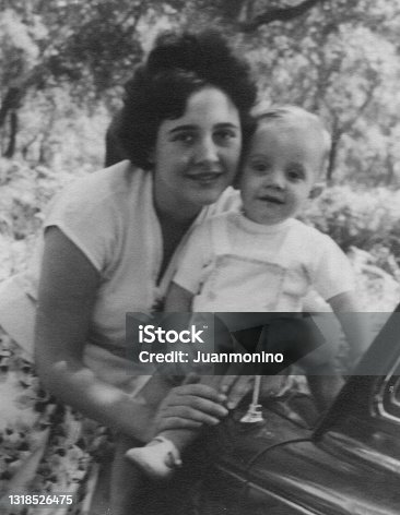 istock Vintage black and white image taken in the 60s of a young woman posing with her toddler son child 1318526475