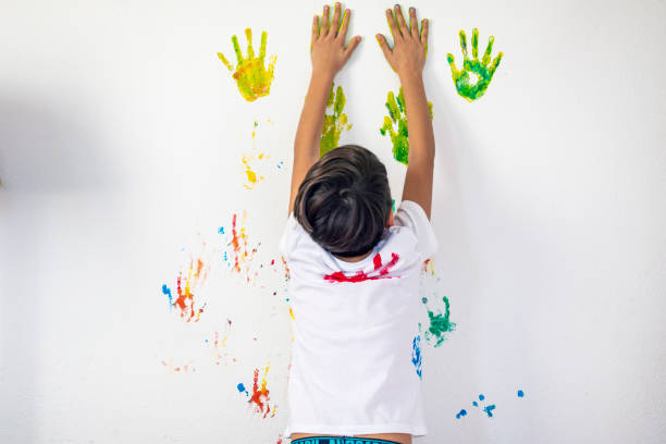 istock Boy Showing Colorful Paint on His Hands 1318527535