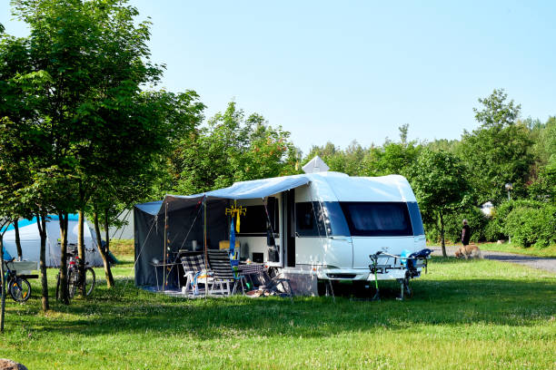湖畔の青空の美しいキャンプ場 - トラベルトレーラー ストックフォトと画像