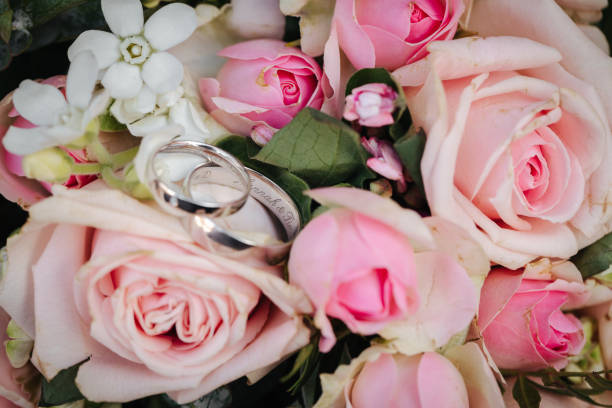 istock Wedding rings close up with flowers 1318530090
