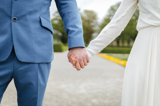 istock Bride and groom holding hands 1318530932