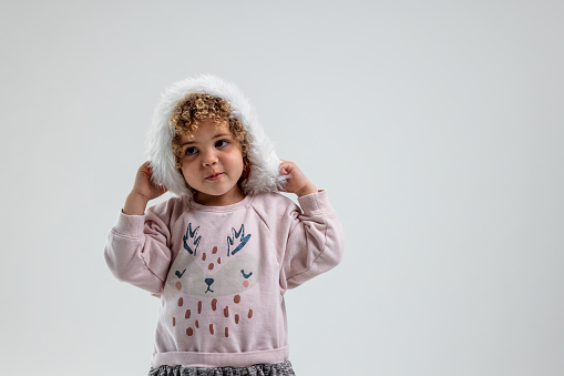 Portrait Of Young Girl Wearing A Santa Hat And Smiling