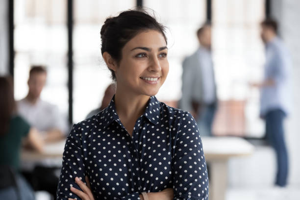 istock Confident smiling Indian female group leader looking at window 1318531415