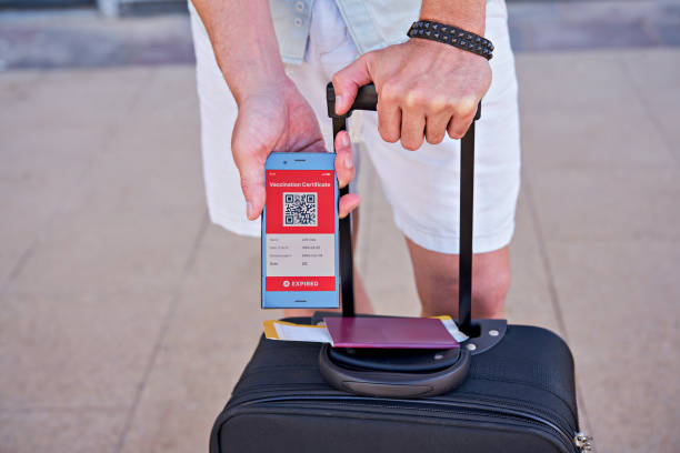 istock Smartphone in hand displaying on app mobile expired digital vaccination certificate for Covid-19 1318532095