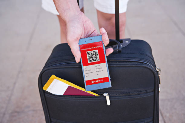 istock Smartphone in hand displaying on app mobile expired digital vaccination certificate for Covid-19 1318532102