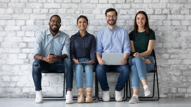 istock Diverse team of confident millennial candidates using digital gadgets 1318533326
