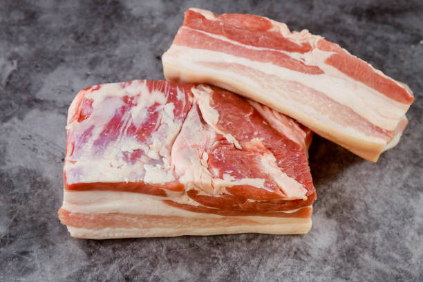 istock Fresh uncooked pork belly on dark background. 1318539797