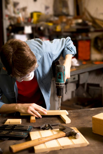 istock Young adult Caucasian male working in small workshop. 1318543158