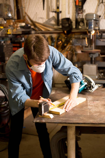 istock Young adult Caucasian male working in small workshop. 1318543314