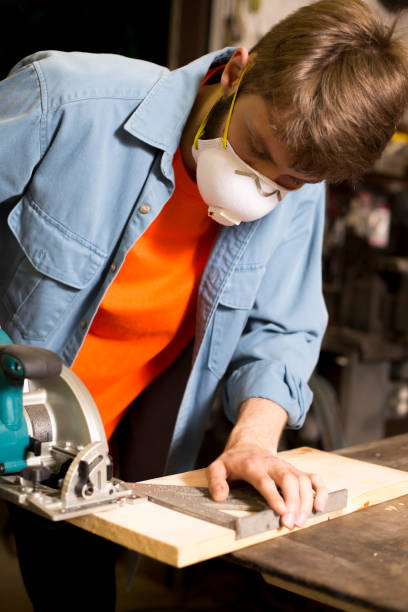 istock Young adult Caucasian male working in small workshop. 1318543325