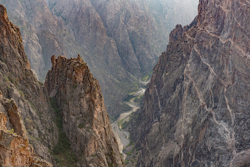 This is a photograph of the rugged landscape at Black Canyon of the Gunnison National Park in Colorado, USA in summer.