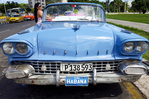 Old, blue car, used for sightseeing, parked in Havana, Cuba.